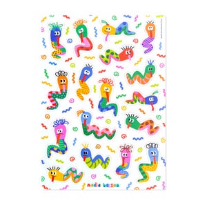 May include: A sticker sheet featuring a collection of colorful, cartoon-style worm characters with various patterns, including polka dots, stripes, and stars. Each worm has a unique color, a long tongue, and hair-like tufts. Text reads NADIAHASSAN.COM.