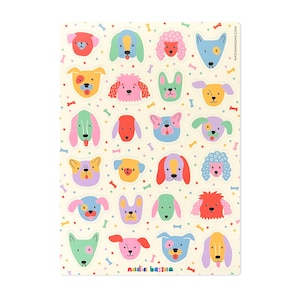 May include: A sheet of colorful dog stickers featuring various breeds in a playful, cartoon style. The stickers showcase a variety of colors and patterns, with a cream-colored background dotted with small bone and dot illustrations. The artist's name, "NADIAHASSAN.COM", is printed on the right side.