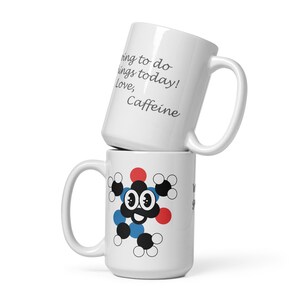 May include: White ceramic coffee mug with the text "Things to do today! Love, Caffeine" on one side and a cartoon caffeine molecule with a smiling face on the other side.