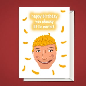May include: A birthday card with a cartoon illustration of a smiling face with yellow hair. The card reads "happy birthday you cheesy little wotsit" in yellow text. The card is white with a red background.