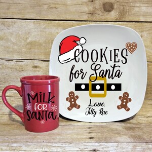 May include: A red ceramic mug with the text "Milk for Santa" and a white ceramic plate with the text "Cookies for Santa" and a Santa hat, a belt with a buckle, and two gingerbread men. The plate also has the text "Love Tilly Rae".