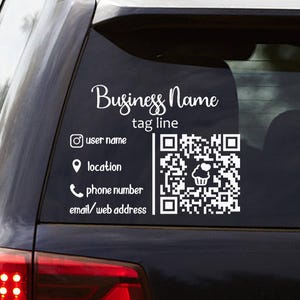 May include: White decal applied to a car window, featuring a business name and tagline in a script font. Includes social media handles, location, phone number, email, and a QR code with a cupcake icon.