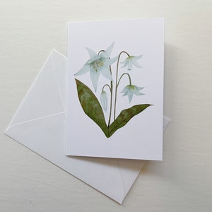 White Lily botanical watercolor painting printed onto a white card. Image is centred on a white cardstock background. White envelope rests below the card.