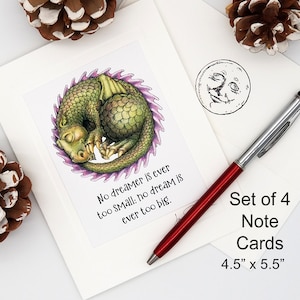 May include: Set of four 4.5" x 5.5" note cards featuring a green dragon curled up sleeping with a purple and green spiky tail. The text reads "No dreamer is ever too small: no dream is ever too big."