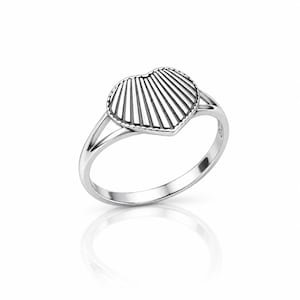 May include: A polished silver ring featuring a heart-shaped centrepiece with a textured, fan-like pattern of radiating lines. The heart is bordered by a delicate beaded edge, and the band splits into two thin, smooth arms where it meets the heart.