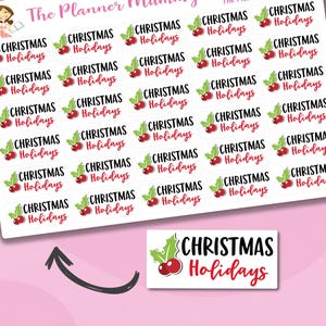 May include: A sheet of Christmas planner stickers. Each sticker has the words "Christmas Holidays" in a festive font, with a red berry and green leaves illustration. The stickers are on a white background, ideal for festive planning.