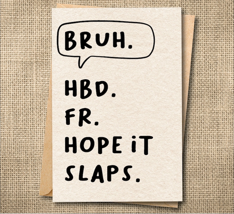 May include: A greeting card with the text "BRUH." in a speech bubble, followed by "HBD. FR. HOPE IT SLAPS." in a bold, black font. The card is light beige and is inside a brown envelope.