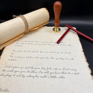 May include: A vintage-style letter with handwritten lyrics from The Beatles' song, "Hey Jude." The letter is aged with a rolled parchment, twine, a wooden stamp, and red sealing wax sticks. The Beatles is written at the bottom.