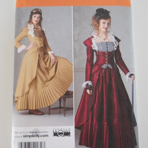 May include: Simplicity sewing pattern number 2172 for sizes 6, 8, 10, and 12. The pattern includes instructions for making two steampunk-inspired dresses. One dress is a brown and beige layered skirt with a fitted jacket. The other dress is a red skirt with a fitted jacket and a white and black striped bodice.
