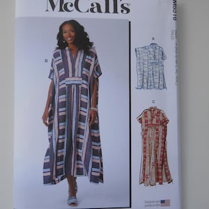 May include: McCall's sewing pattern for a maxi dress with a striped pattern. The pattern includes three different styles: a V-neck dress with a tie, a collared dress with a tie, and a collared dress with a gathered bodice. The pattern is available in sizes XS-S-M-L-XL-XXL. The pattern is designed and printed in the USA.