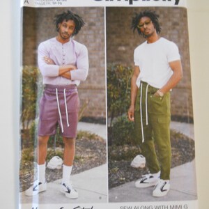May include: A Simplicity sewing pattern for men's clothing, featuring two models wearing different styles of pants and shirts. The pattern number is S9338. The text "Mimi G Style" is written in a stylized font at the bottom of the image.