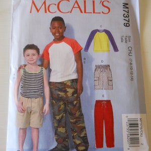 May include: Sewing pattern for boys' clothing, McCall's pattern number M7379, size CHJ (7-8-10-12-14). The pattern includes instructions for making a striped tank top, camouflage pants, a yellow long-sleeve shirt with a purple collar, striped pants, and red pants.