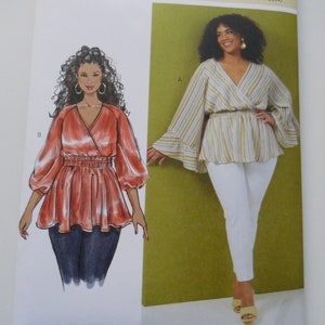 May include: A sewing pattern for a women's blouse with a wrap style neckline and long sleeves. The pattern is for sizes 20W-22W-24W-26W-28W. The pattern is from Butterick and has the number B6931.