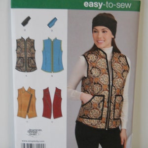 May include: A sewing pattern for a vest with a zipper closure. The pattern includes instructions for making a vest with a paisley print, a solid blue vest, and a brown vest with a zipper detail. The pattern is for sizes US 10-24, Talla Euro 40-50, and Talla FR 44-52. The pattern is from Simplicity and is easy-to-sew.