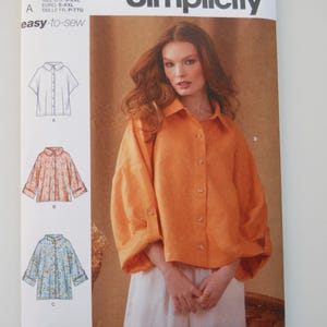 May include: Simplicity sewing pattern number S9952, easy-to-sew, for a shirt with a collar and button closure. The pattern includes three different views: a short-sleeved shirt, a long-sleeved shirt with a gathered cuff, and a long-sleeved shirt with a gathered cuff and a floral print.