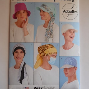 May include: Simplicity sewing pattern S9491 for making hats. The pattern includes five different hat styles: a pink cloche hat, a blue and white patterned hat with a brim, a white hat with a brim, a black and white patterned turban, and a yellow and brown patterned turban with a blue face mask.