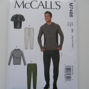 May include: McCall's sewing pattern M7486 featuring athletic wear designs. The pattern includes illustrations of a hooded sweatshirt, long-sleeve shirt, t-shirt, and joggers. The package is white with black and gray text and images.