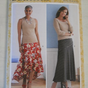 May include: A sewing pattern for a skirt, featuring two different styles. The first style is a red and white floral print skirt with a high-low hemline. The second style is a black and white striped skirt with a straight hemline. The pattern is from Butterick and is for sizes 16-22.
