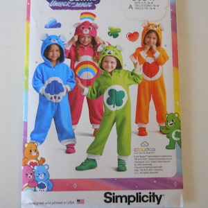 May include: Care Bears Unlock the Magic sewing pattern for children's costumes. The pattern includes four different Care Bear costumes: blue with a cloud, pink with a rainbow, green with a shamrock, and orange with a heart. The pattern is for sizes 14-4.