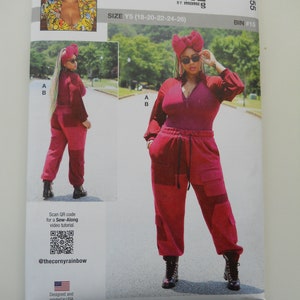 May include: A sewing pattern for a red jumpsuit with a zipper and cargo pockets. The pattern is called "knowME" by mimig and is size Y5 (18-20-22-24-26). The pattern includes a QR code for a sew-along video tutorial.