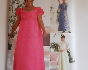 May include: Simplicity sewing pattern S9502 for sizes 20W-28W, 46-54, and 48-56. The pattern includes three different dress designs: a pink dress with a ruffled neckline, a blue dress with a long sleeve and a white dress with a long sleeve.