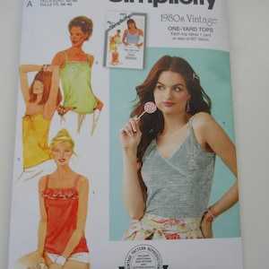 May include: Simplicity sewing pattern for 1980s vintage one-yard tops. The pattern includes four different styles of sleeveless tops, with a variety of necklines and straps. The pattern is labeled "S9967" and is designed and printed in the USA.