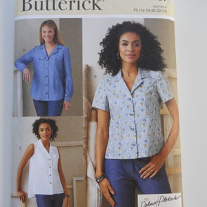 May include: A Butterick sewing pattern envelope featuring three shirt designs. The envelope displays images of the shirts, including a long-sleeved blue shirt, a short-sleeved patterned shirt, and a white sleeveless shirt. The pattern number is B6924.