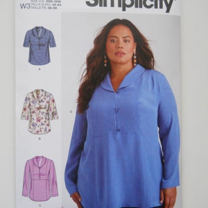 May include: Simplicity sewing pattern number S9890 for a long-sleeved blouse with a collar. The pattern includes three different views: a blue blouse, a floral blouse, and a pink blouse. The pattern is for sizes US 30W-38W, Talla Euro 56-64, and Taille FR 58-66.