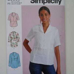 May include: Simplicity sewing pattern number S9889 for a collared blouse with short sleeves. The pattern includes three different views: a pink blouse, a floral blouse, and a light blue blouse. The pattern is for sizes US 12-20, Euro 38-46, and French 40-48.