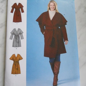 May include: Simplicity sewing pattern number S8990, size US 6-14, talla euro 32-40, taille fr 34-42, H5. The pattern includes three different styles of a wrap coat: a brown coat with a belt, a gray coat with a belt, and a yellow coat with a belt.