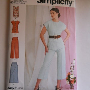 May include: A sewing pattern for a women's outfit, featuring a top, pants, and skirt. The pattern is from Simplicity and is labeled S9479. The pattern includes sizes 6-14, 32-40, and 34-42.