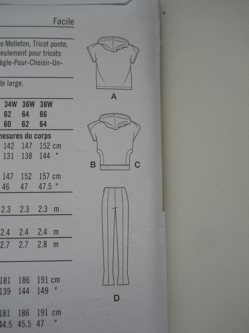 May include: A sewing pattern with instructions for making a hooded top and pants. The pattern includes measurements in inches and centimeters.