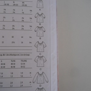 May include: A sewing pattern for a simple, loose-fitting blouse with different sleeve lengths. The pattern includes instructions for sizes L, XL, XXL, and a chart with measurements in inches and yards.