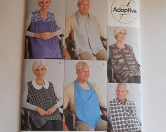 May include: Simplicity sewing pattern S9489, Adaptive easy-to-sew, one size, for making bibs and neck coverings. The pattern shows five different styles of bibs and neck coverings, including a blue bib, a white bib with black polka dots, a gray bib, a patterned bib, and a plaid bib.
