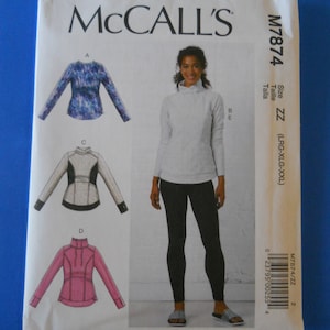 May include: McCall's sewing pattern M7874. The pattern features illustrations of athletic tops with long sleeves and a mock neck. The size is ZZ (LRG-XLG-XXL). The cover shows a woman wearing a light gray top and black leggings.