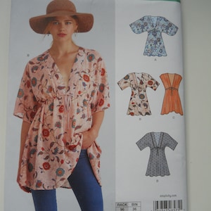 May include: A sewing pattern for a dress with a V-neck and a tie at the waist. The pattern includes three different styles: a floral print, a solid orange, and a polka dot print. The pattern is for sizes XS-XL.