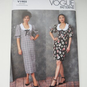 May include: Vogue Patterns sewing pattern for a dress with a Peter Pan collar. The pattern is for sizes Y5 (18-20-22-24-26) and is a Custom Fit pattern for ABCD cup sizes. The pattern is designed and printed in the USA.