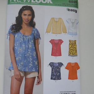May include: A sewing pattern for a blouse with different variations. The pattern is from Newlook and is size A, US 10-22, FR 30-50, EURO 36-48. The pattern includes instructions for making a blouse with a scoop neck, short sleeves, and a tie at the neck. The pattern also includes instructions for making a blouse with long sleeves and a tie at the neck.