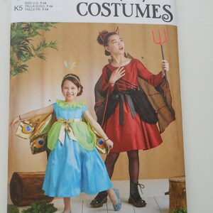 May include: Simplicity Costumes pattern S9841 featuring two children's costume designs. One is a blue and green butterfly dress, and the other is a red devil costume with a black cape. The pattern is designed and printed in the USA.