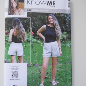 May include: A sewing pattern package with the text "knowME by mimiG" and size information. The package features images of a woman wearing shorts and a black top. The package also includes a QR code and the text "Designed and printed in USA."