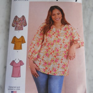 May include: Simplicity sewing pattern S9334, featuring a woman wearing a floral print top. The pattern includes size options from U.S. 10-18. The package is white with the text "Simplicity" and "Designed and printed in USA."