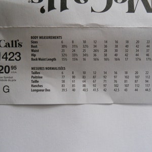 May include: A McCall's sewing pattern with the pattern number R11423 and a price of $20.95. The pattern includes body measurements in inches for sizes 6 to 24 and corresponding measurements in centimeters for French sizes 6 to 24.