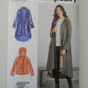 May include: Simplicity sewing pattern S9713 for sizes US 18-26, Euro 44-52, and French 46-54. The pattern includes instructions for making a long hooded jacket with a high-low hemline. The jacket is shown in two different color variations: a blue raincoat and a gray jacket with a floral print.