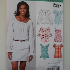 May include: A sewing pattern for a blouse with different styles. The pattern includes a white blouse with a scoop neck, a red and white floral blouse, a blue and white floral blouse, a red and white plaid blouse, and a geometric patterned blouse. The pattern is for sizes 8-10, 34-44, 32-42. The pattern is from New Look and is called "Easy 2 Hour".
