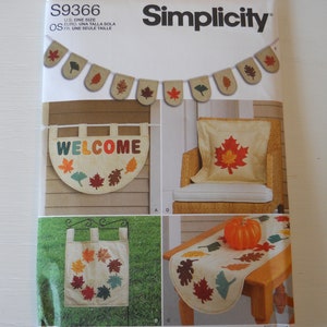 May include: Simplicity sewing pattern S9366 featuring autumn-themed home decor projects. The pattern includes designs for a banner, welcome sign, pillow, table runner, and garden flag, all adorned with colorful leaf motifs.