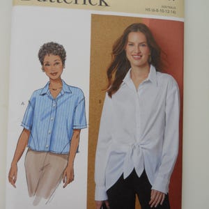 May include: A Butterick sewing pattern envelope, B7011, featuring illustrations of two button-down shirts. One is blue striped, the other is white and tied at the waist. The text "Butterick" is at the top.