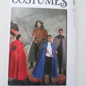 May include: McCall's Costumes sewing pattern for a fantasy costume. The pattern includes four different cape designs, including a red cape with a dragon symbol, a blue cape, a brown cape with a hood, and a black cape. The pattern is for sizes S-M-L-XL-XXL.