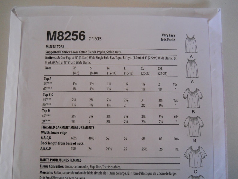 May include: A sewing pattern for tops, labeled M8256, with instructions for sizes XS to XXL. The pattern includes seven pieces and is rated as very easy to sew. The pattern includes a table with measurements for different sizes and types of tops.