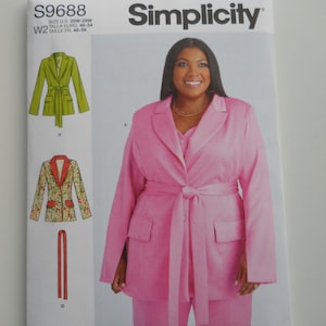 May include: Simplicity sewing pattern number S9688 for a blazer and pants. The pattern is for sizes 20W-28W, 46-54 Euro, and 48-56 French. The pattern shows a pink blazer and pants with a self-tie belt.