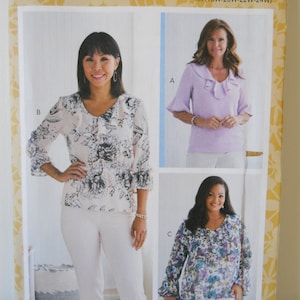May include: A sewing pattern for a women's blouse with three different styles. The pattern is from Butterick and the pattern number is B6814. The pattern includes sizes 18W-20W-22W-24W.